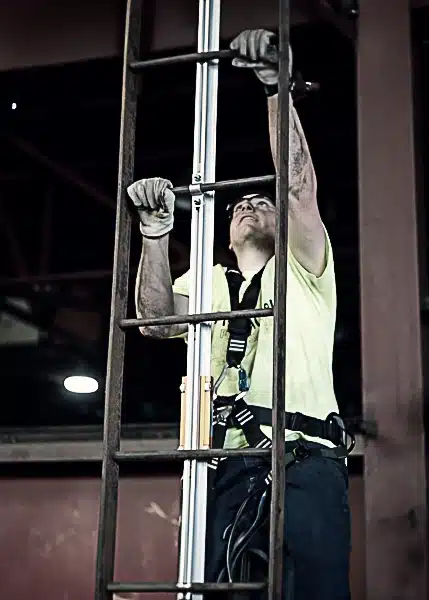 Worker Climbing FrenchCreek Rigid Rail Ladder Safety System