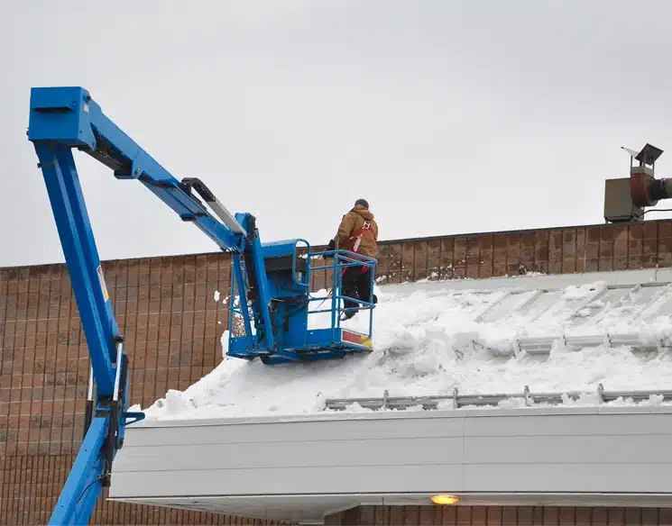 Worker Working On A Rooftop In Winter Conditions