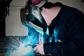 Denny showcasing his welding expertise