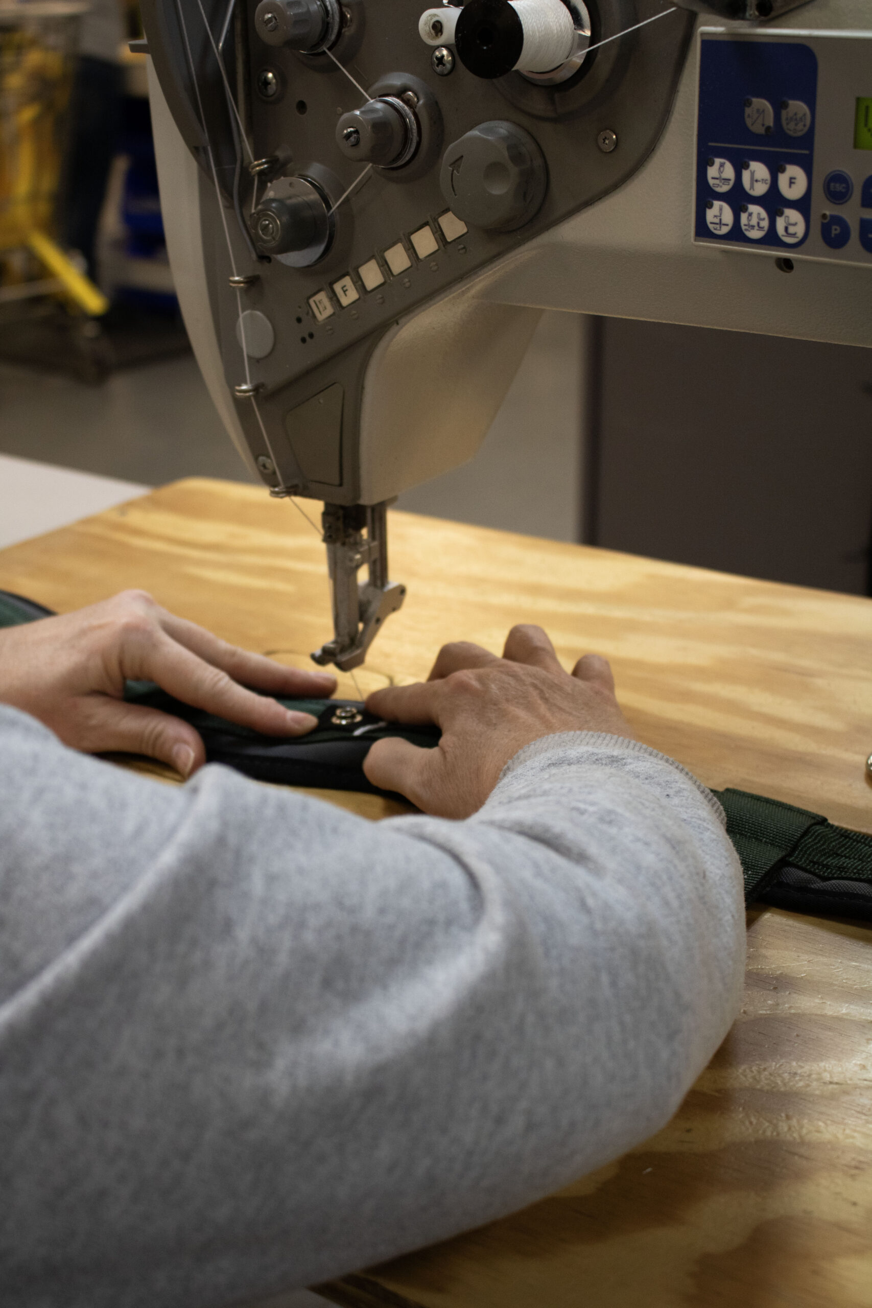 FC Safety employee using an industrial sewing machine to sew a fall-protection harness in Franklin, Pennsylvania