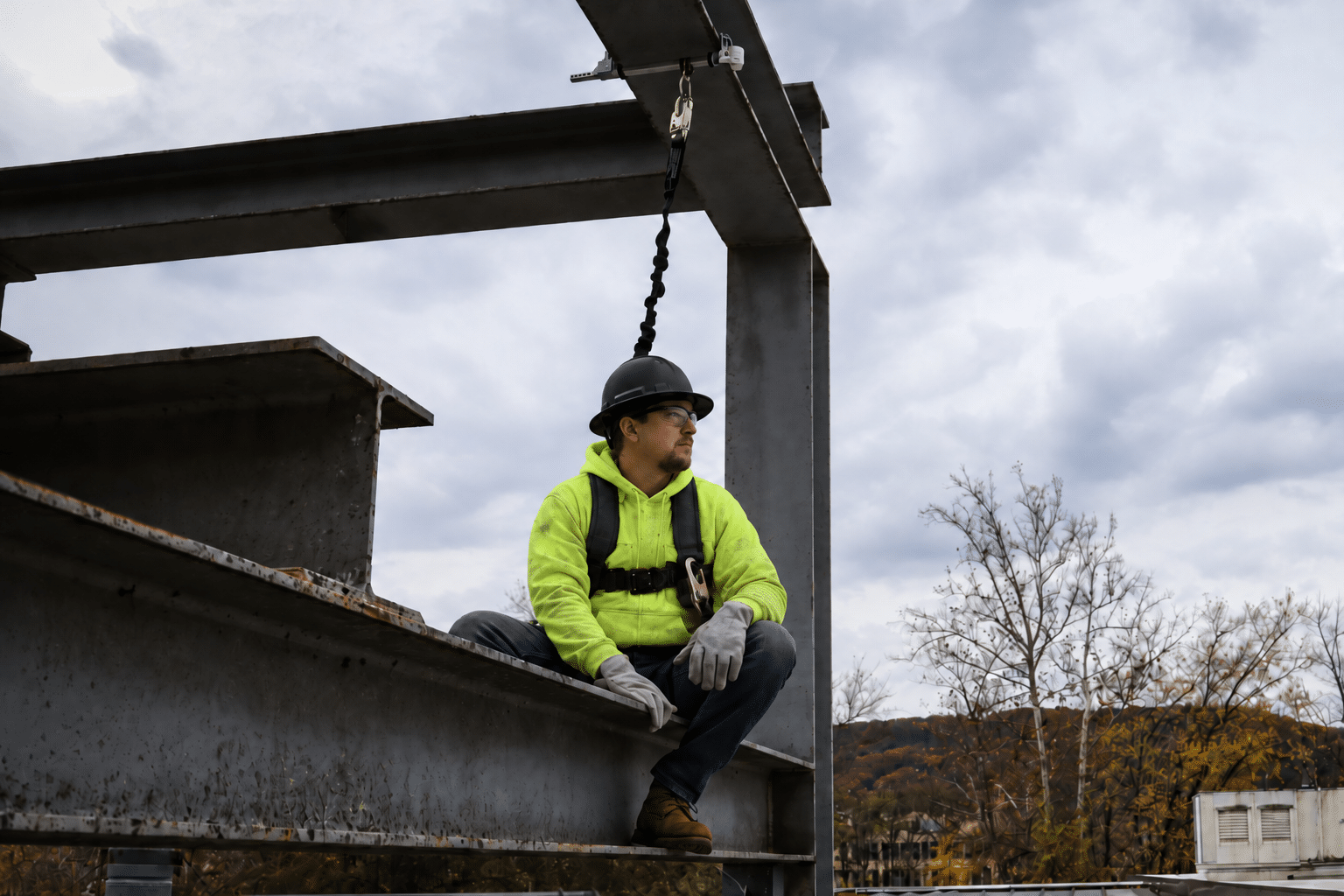 Worker using FC Safety fall protection equipment high above a steel structure